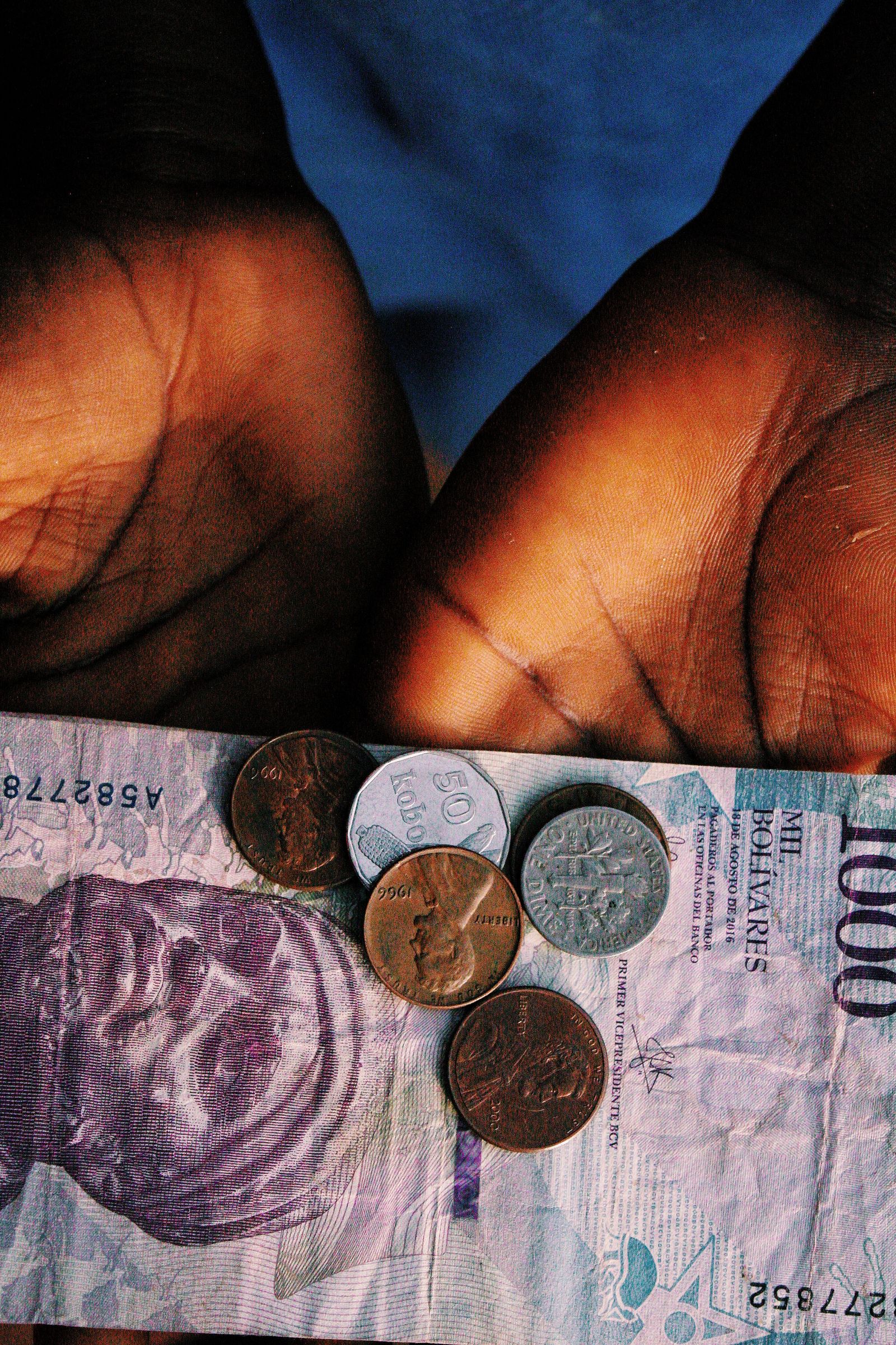 Hands holding banknotes and coins