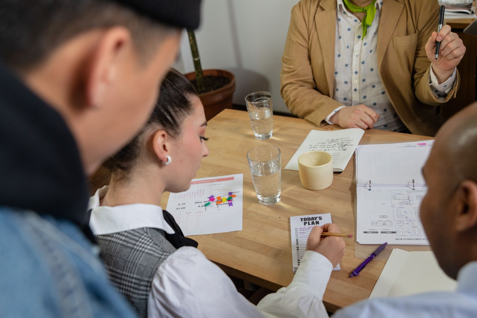 A diverse group reviewing documents together at a table